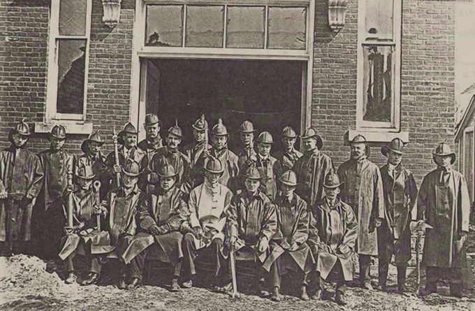 Chief Patterson (seated in center with lighter coat) and the Pioneer Hook and Ladder Co. No. 1 firefighters, 1913