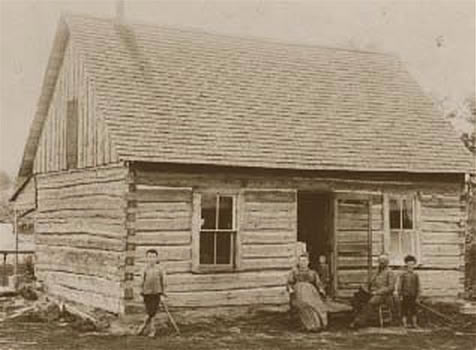 Dr. Aker and family outside their homestead cabin
