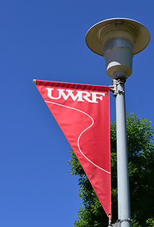 UWRF light pole banner on a blue-sky day