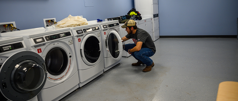 The McMillan Hall basement laundry room has four washers and four dryers