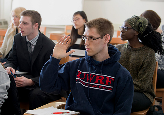Student raising their hand during class