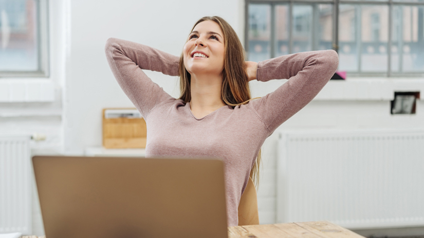 Woman relaxing near computer smiling