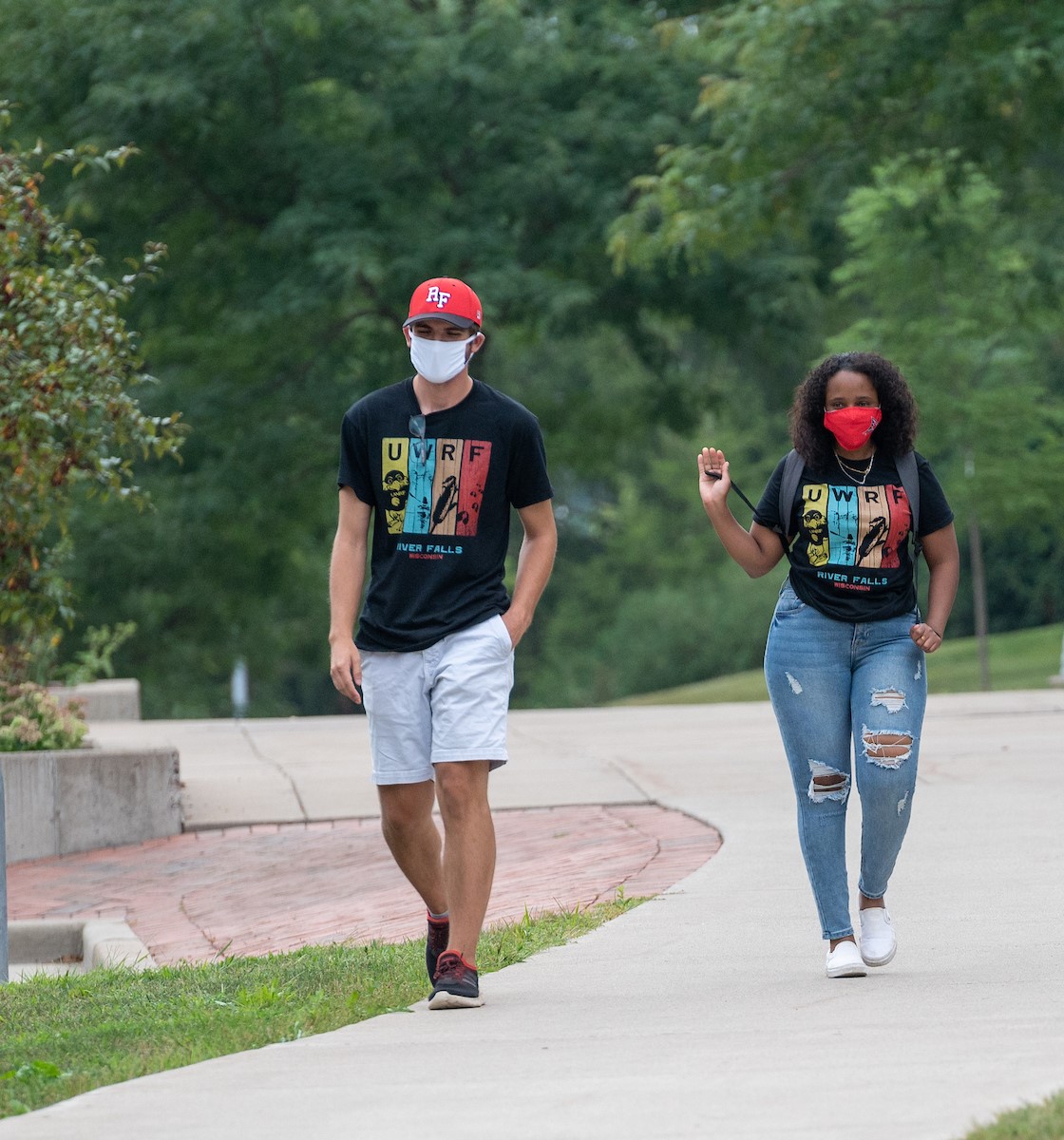 Students walking with masks on while physically distancing on campus