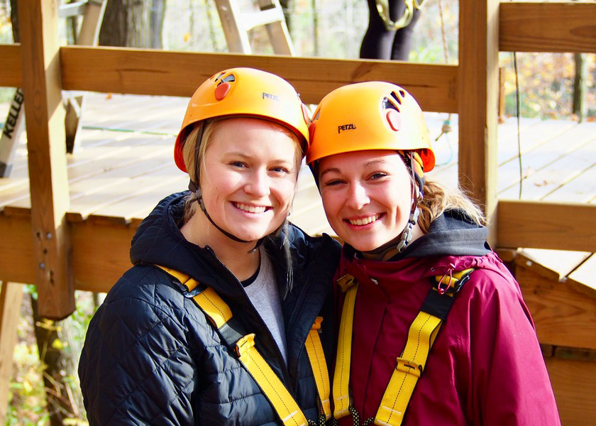 Two students wearing helmets