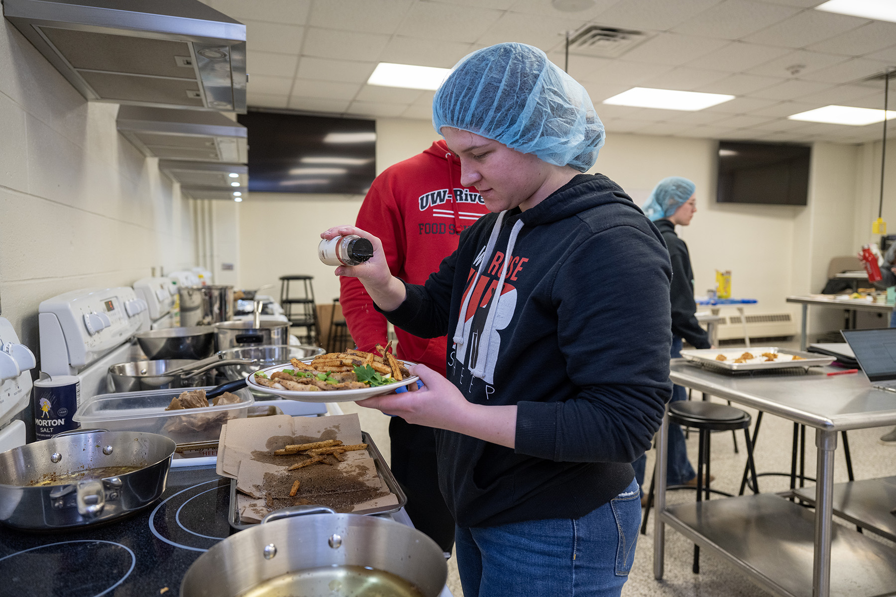 Essie Whitehead, a food science major from Amery, finishes preparing a meal during her food product development and sensory evaluation class March 22. 