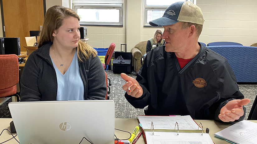 Humane Handling Institute Program Manager Ashlynn Kirk listens to Brandon Clare, owner of JM Watkins meat processing plant in Plum City