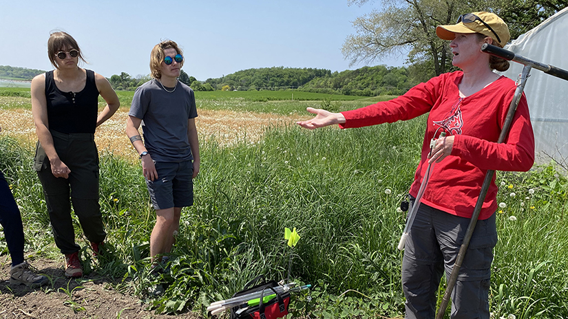 Jill Coleman Wasik explains measuring water in the soil to students on May 25 at the university-operated Mann Valley Farm. 