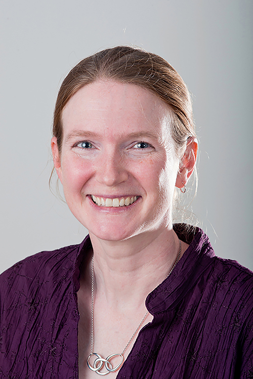 Headshot of Jill Coleman Wasik, a white woman with brown hair wearing a purple sweater and a silver necklace