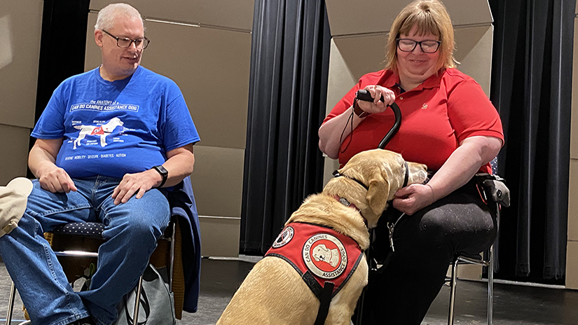 Amy Sabot, right, said her service dog, Mabel, a 6-year-old yellow lab, not only helps her perform a variety of physical tasks she can’t do on her own but provides emotional support as well. 