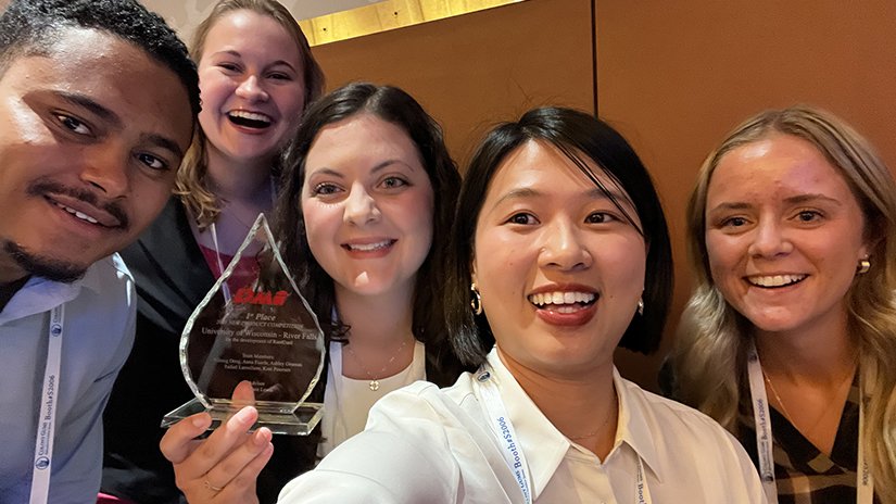 Students holding award for winning the RootCurd national competition