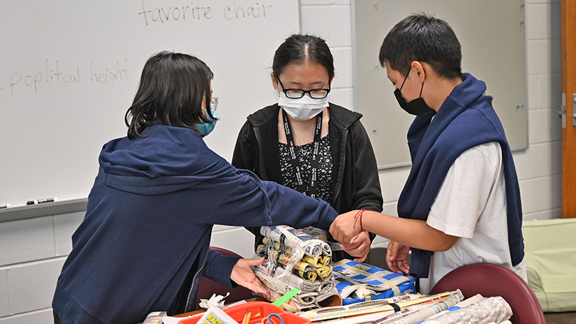 Washington Technology Magnet High School students build a chair out of newspapers as part of an Upward Bound class.