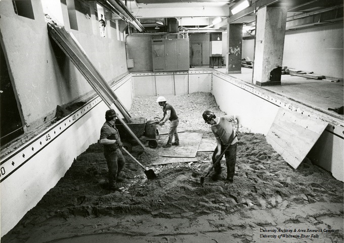 Swimming pool in the basement of North Hall being filled in to create classroom space, 1980