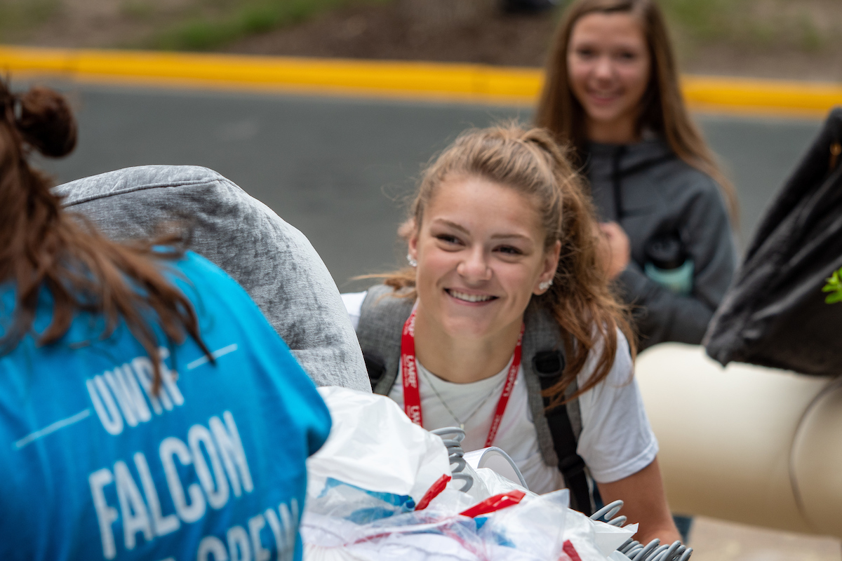 Students move belongings into their residence hall