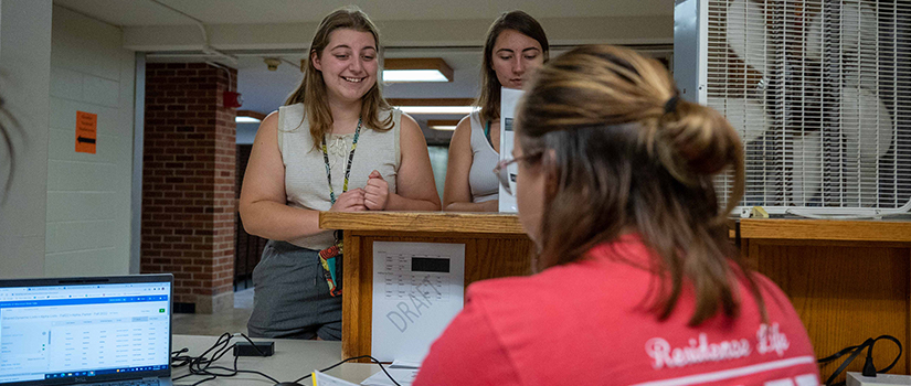 Resident Assistants help check students in on move in day