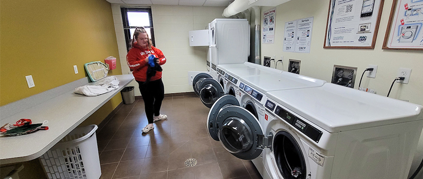 Ames laundry room including multiple washers and dryers, and countertop