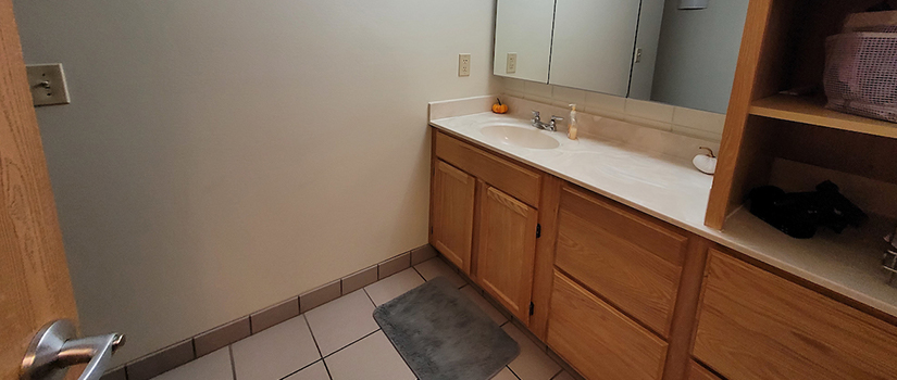South Fork Suites bathroom vanity including sink, mirror, cubbies, and drawers