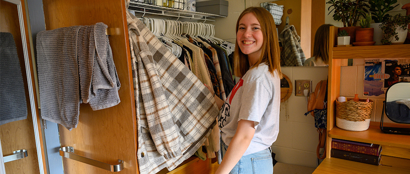 A student looks through their closet in McMillan hall