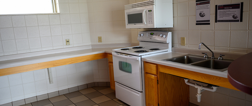 South Fork Suites common area kitchen including oven, stove, microwave, sink, and countertop