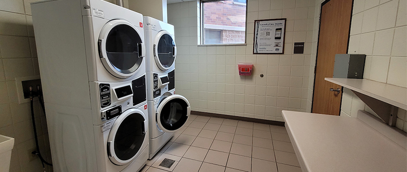 South Fork Suites common area laundry including two washers, two dryers, and countertops