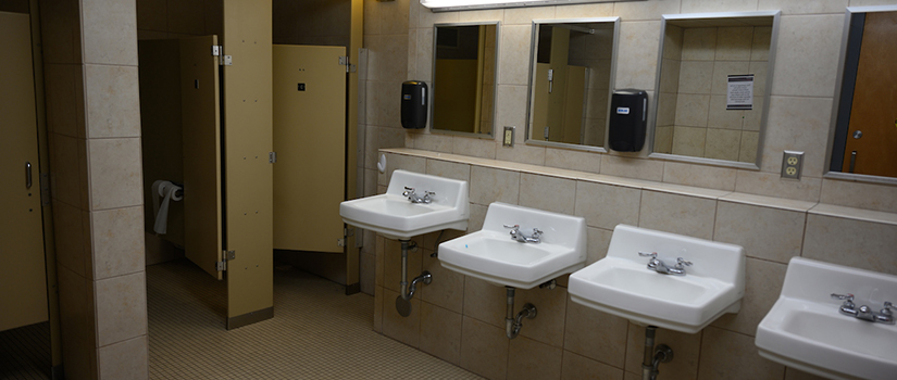 Community bathrooms in Crabtree hall are designated by gender and include multiple sinks, mirrors, hand dryers, outlets, toilet stalls, and shower stalls.