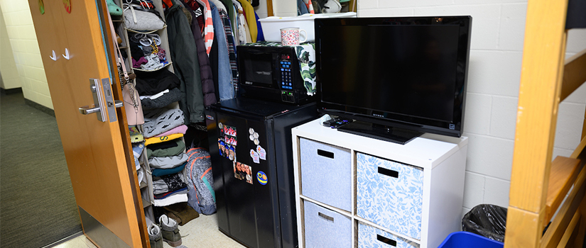 A closet within a double occupancy room in Crabtree hall. A microwave and minifridge unit are supplied as well.