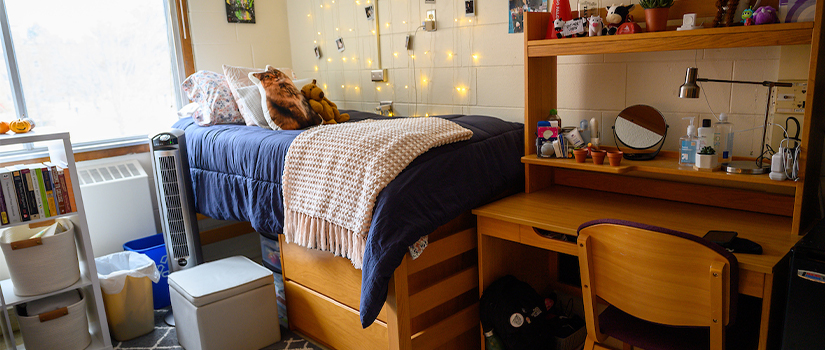 A McMillan Hall room including a bed, desk, and chair