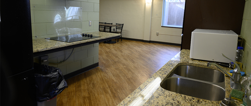 Johnson Hall kitchen includes a full size refrigerator, sink, oven, stove, and countertops