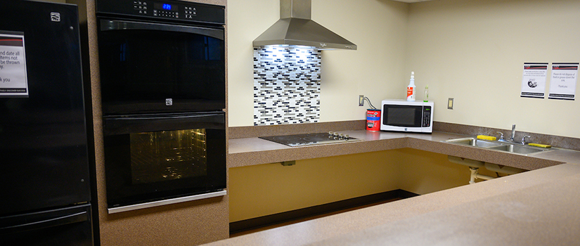Prucha Hall kitchen contains two ovens, a range, a full size refrigerator, a sink, and lots of counterspace
