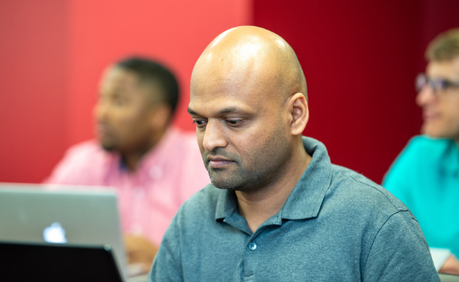 Graduate student looking at laptop