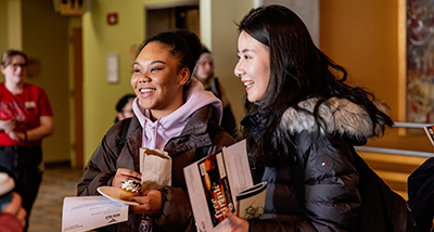 Two female students talk to another student during the Involvement Fair in the University Center