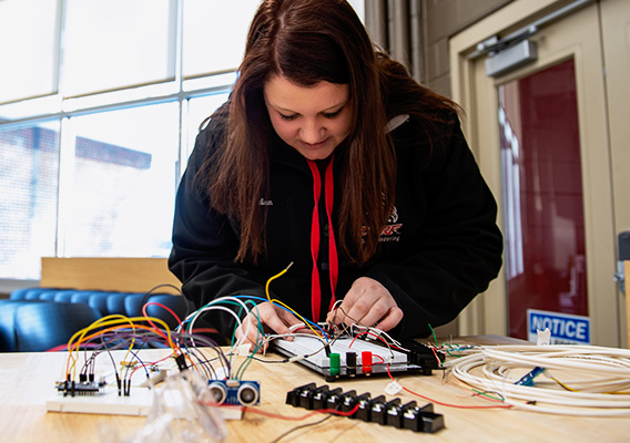 Engineering technology student practices electric wiring in class