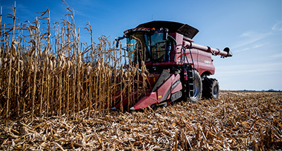 Students test out new combine in a field at the Mann Valley Farm