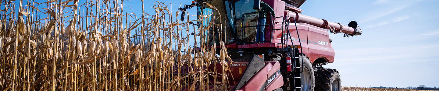 Students test out new combine in a field at the Mann Valley Farm