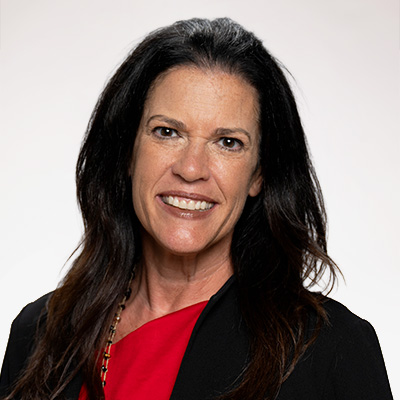 Headshot of Amy Clark, a woman with long black hair wearing a red blouse and black blazer
