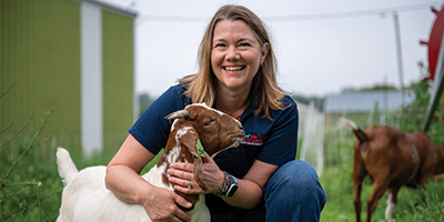 Angela on campus farm with goats