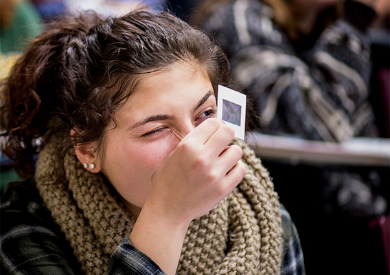 Student looks through a viewfinder during an Astronomy class