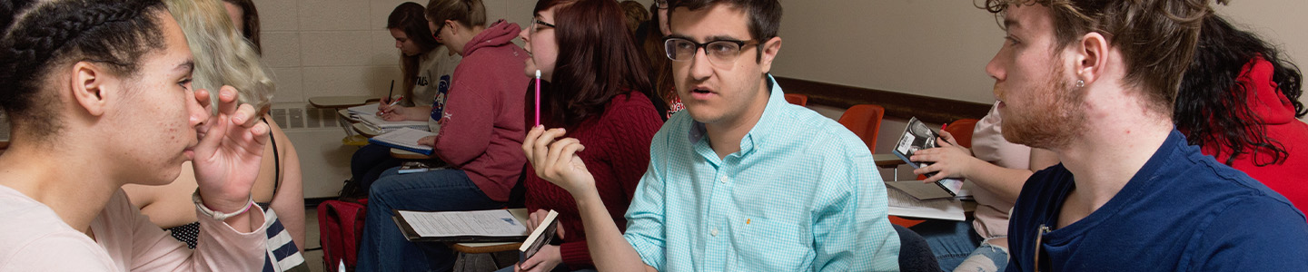 Three students discussing coursework in a Marketing class