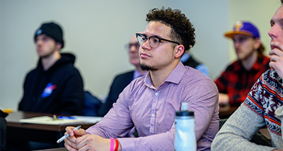 Student listens to their marketing professor in class