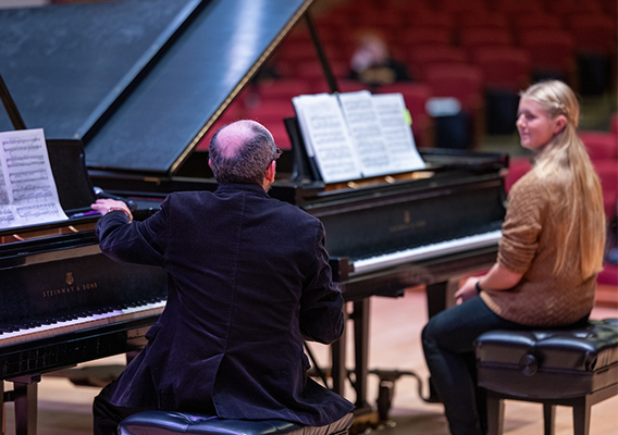 guest artist meeting with student for master class in piano