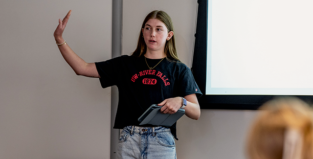 A student studying social work gives a presentation to their class