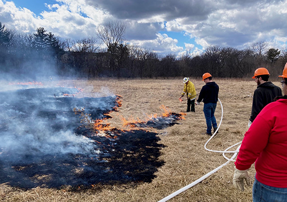 Conservation students participate in a prescribed campus field burn