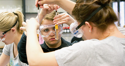 Student analyzes the substance in a glass vial