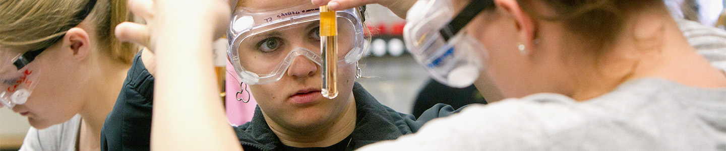 Student analyzes the substance in a glass vial