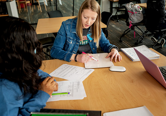 Three students attend a tutoring session