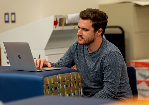 Student takes notes on their laptop during class