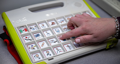 A student prepares to press a button on an auditory testing device