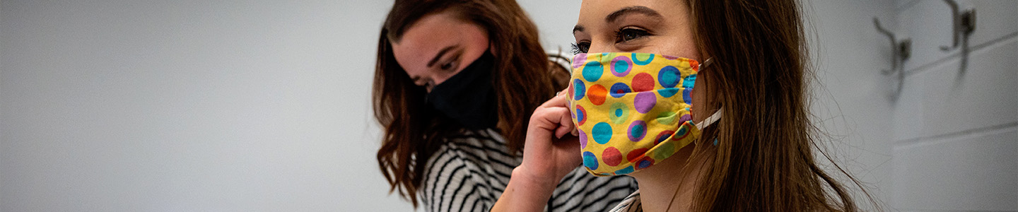 Communication Sciences student inspects the ear canal of another student