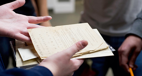 Students view the archives room in the campus library