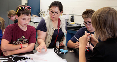 Three high schoolers participate in a science camp