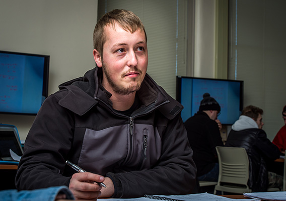 Student listens to professor during Computer Science class